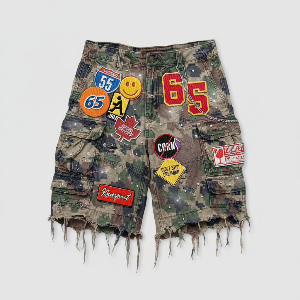 Camouflage shorts with various patches on a dark background